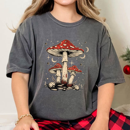 May include: A gray t-shirt with a graphic of three red and white mushrooms with white stems against a dark blue background with white stars and crescent moons.
