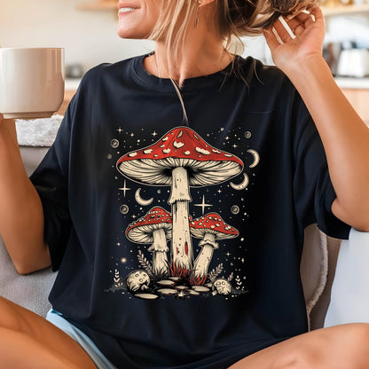 May include: Black t-shirt with a graphic of three red and white mushrooms with white stems against a dark blue background with white stars and crescent moons.