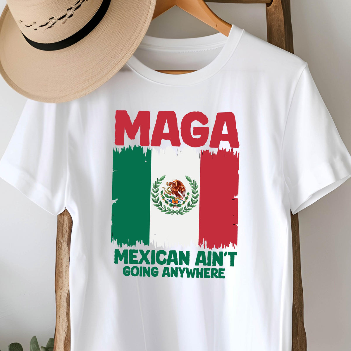 May include: White t-shirt with a red, white, and green Mexican flag and the text "Maga Mexican Ain't Going Anywhere".