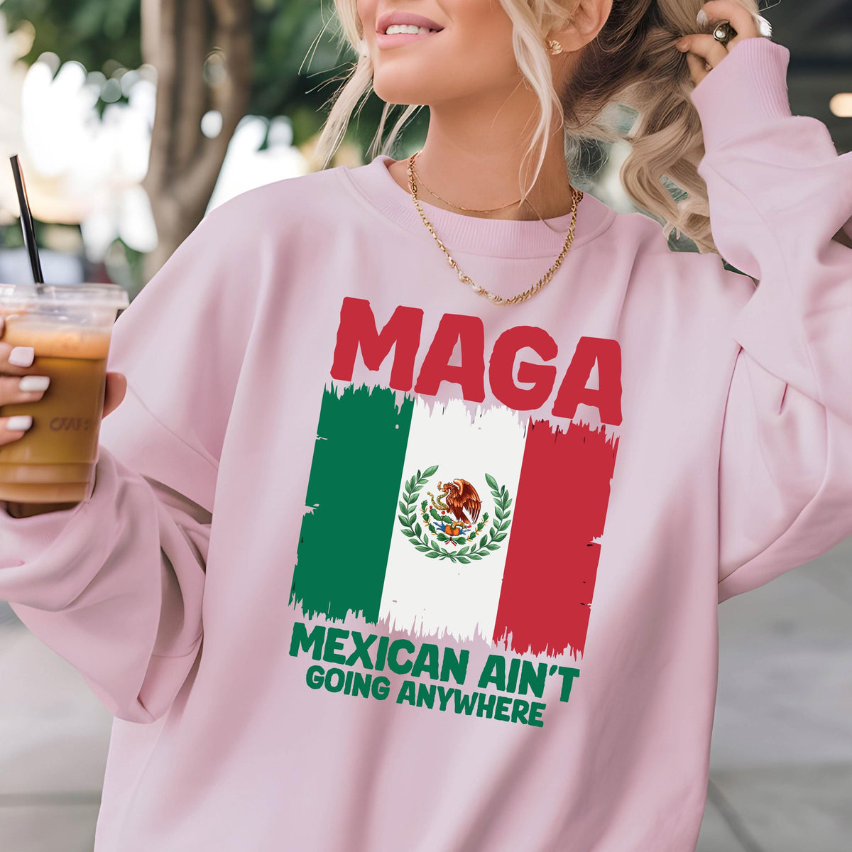 May include: Pink sweatshirt with a distressed Mexican flag and the text "Maga Mexican Ain't Going Anywhere".