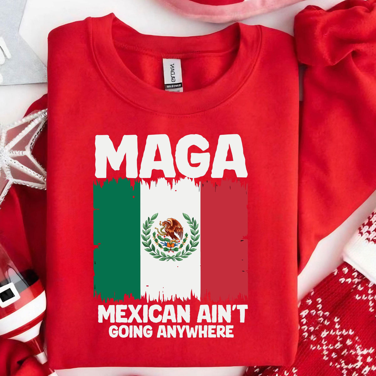 May include: Red t-shirt with white text that reads "MAGA MEXICAN AIN'T GOING ANYWHERE" and a graphic of the Mexican flag.