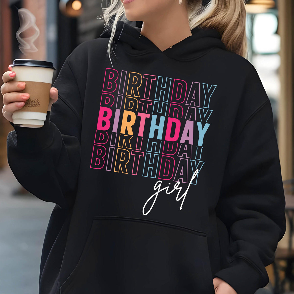 May include: Black hoodie with a colorful "Birthday girl" graphic. The text is stacked and outlined in different colors, including pink, yellow, blue, and green.
