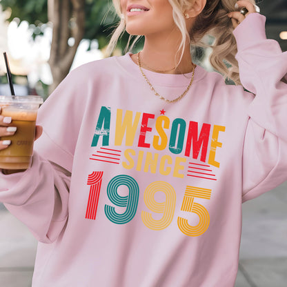 May include: Pink sweatshirt with a retro-style graphic that says "Awesome Since 1995" in colorful letters.