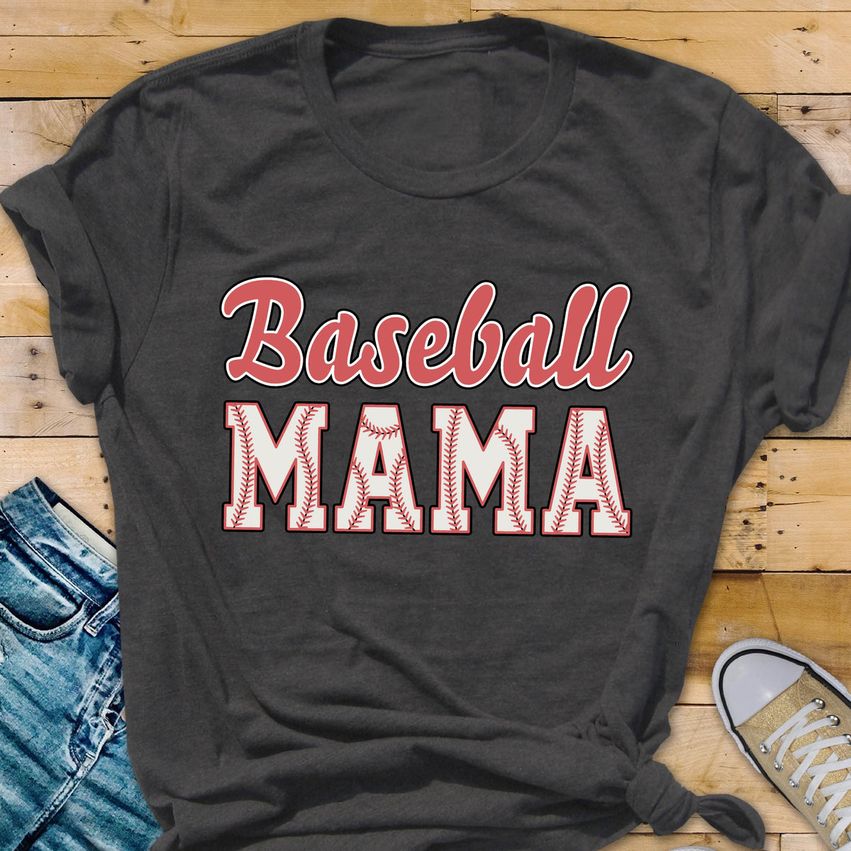 May include: A dark gray t-shirt with the text "Baseball Mama" in red and white lettering. The word "Mama" is surrounded by a white baseball with red stitching.