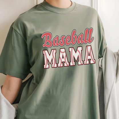 May include: A green t-shirt with the text "Baseball Mama" in red and white lettering. The letters are outlined in white and have a baseball stitch design.