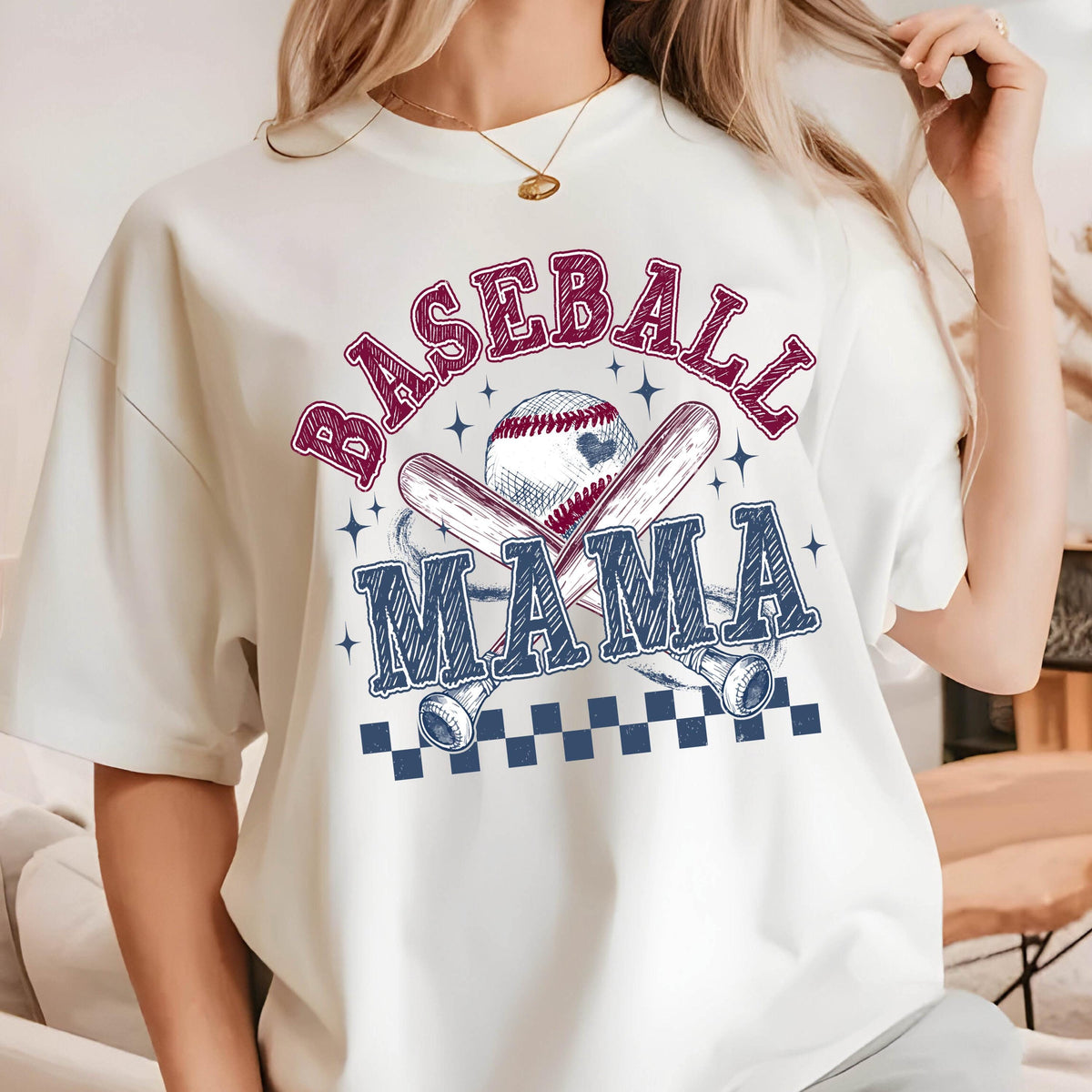 May include: White t-shirt with a blue and red graphic design that says "Baseball Mama" with a baseball and crossed bats.