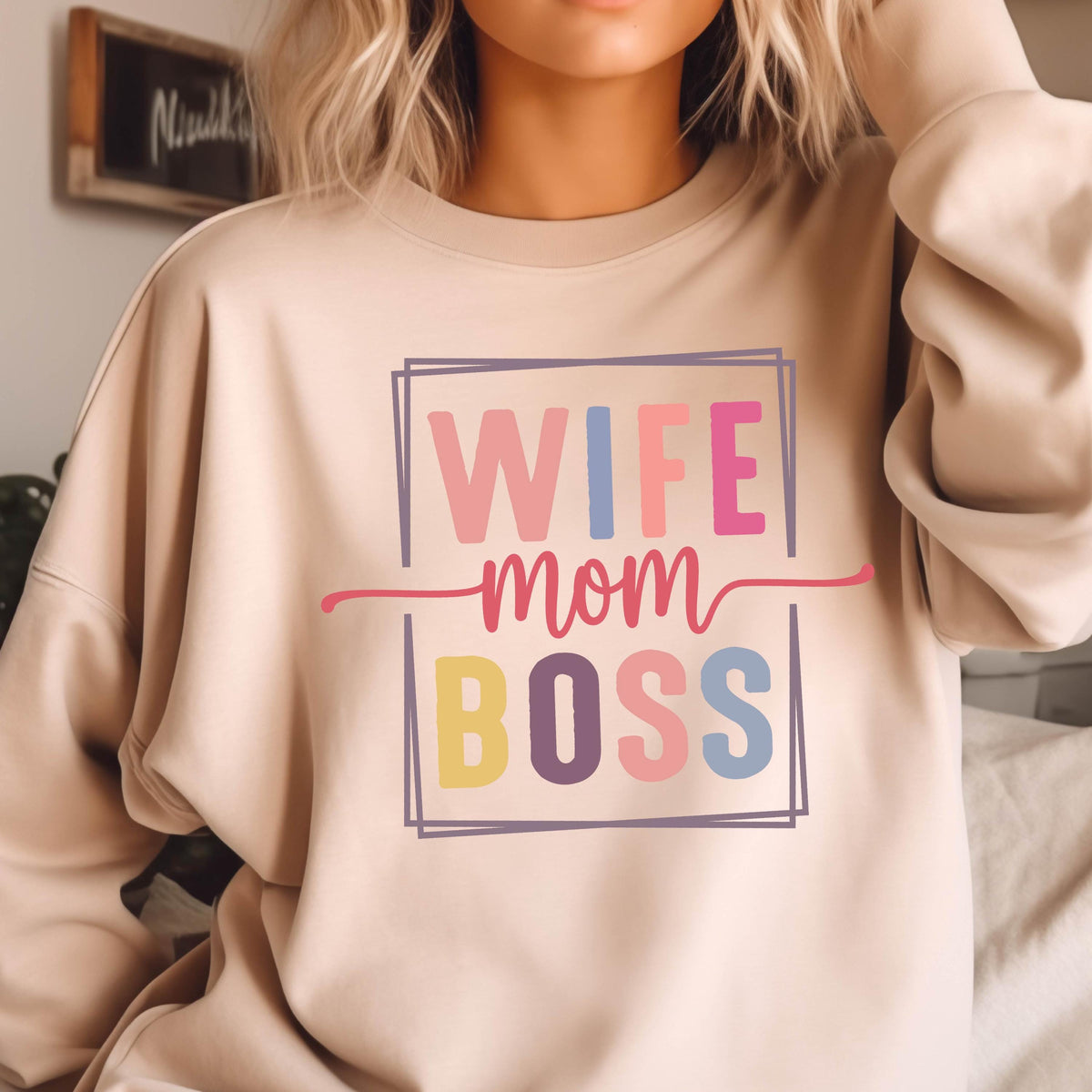 May include: A light beige sweatshirt with the text "WIFE MOM BOSS" in a colorful block font.