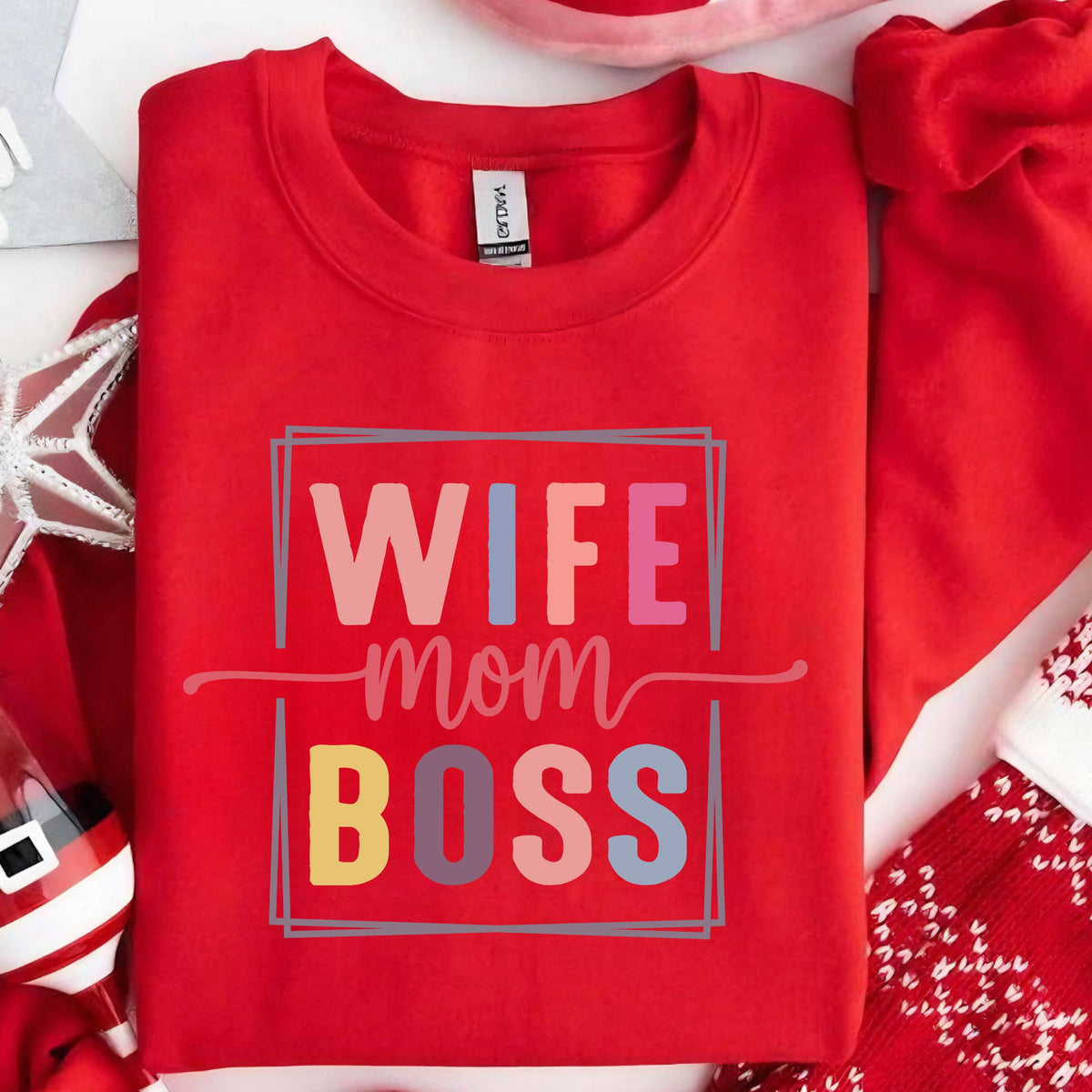 May include: Red sweatshirt with the text "Wife Mom Boss" in a colorful, rectangular box. The text is in a playful, colorful font.