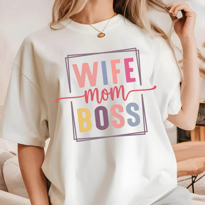 May include: White t-shirt with a colorful graphic that says "Wife Mom Boss" in a box.