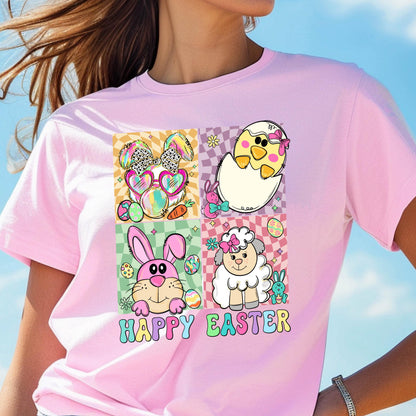 May include: Pink t-shirt featuring a colorful Easter-themed graphic. The design includes a bunny wearing sunglasses, a chick hatching from an egg, a pink bunny, and a sheep. The words "HAPPY EASTER" are printed in a rainbow font.