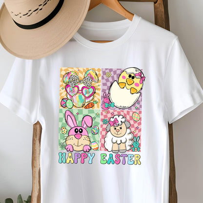 May include: White t-shirt featuring a colorful Easter-themed graphic. The design includes cartoon images of a bunny, chick, and lamb, along with the words "HAPPY EASTER" in a playful font. The shirt is hanging on a wooden hanger.