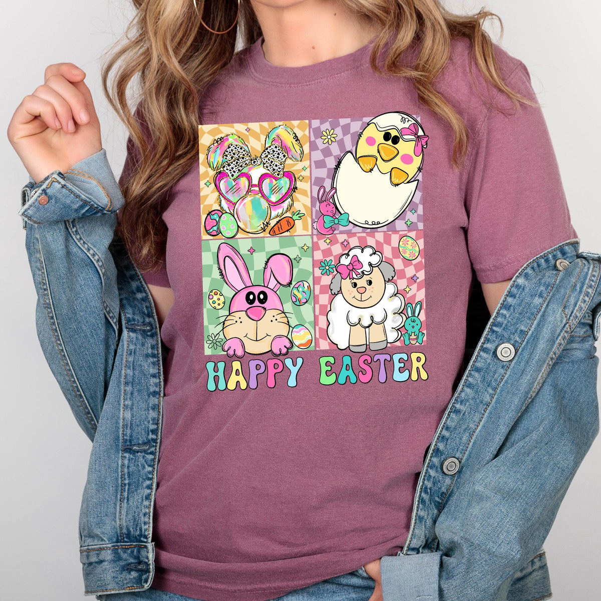 May include: A pink t-shirt with a graphic of four Easter animals in a grid pattern. The animals are a bunny, a chick, a lamb, and a bunny wearing sunglasses. The text "Happy Easter" is below the grid.
