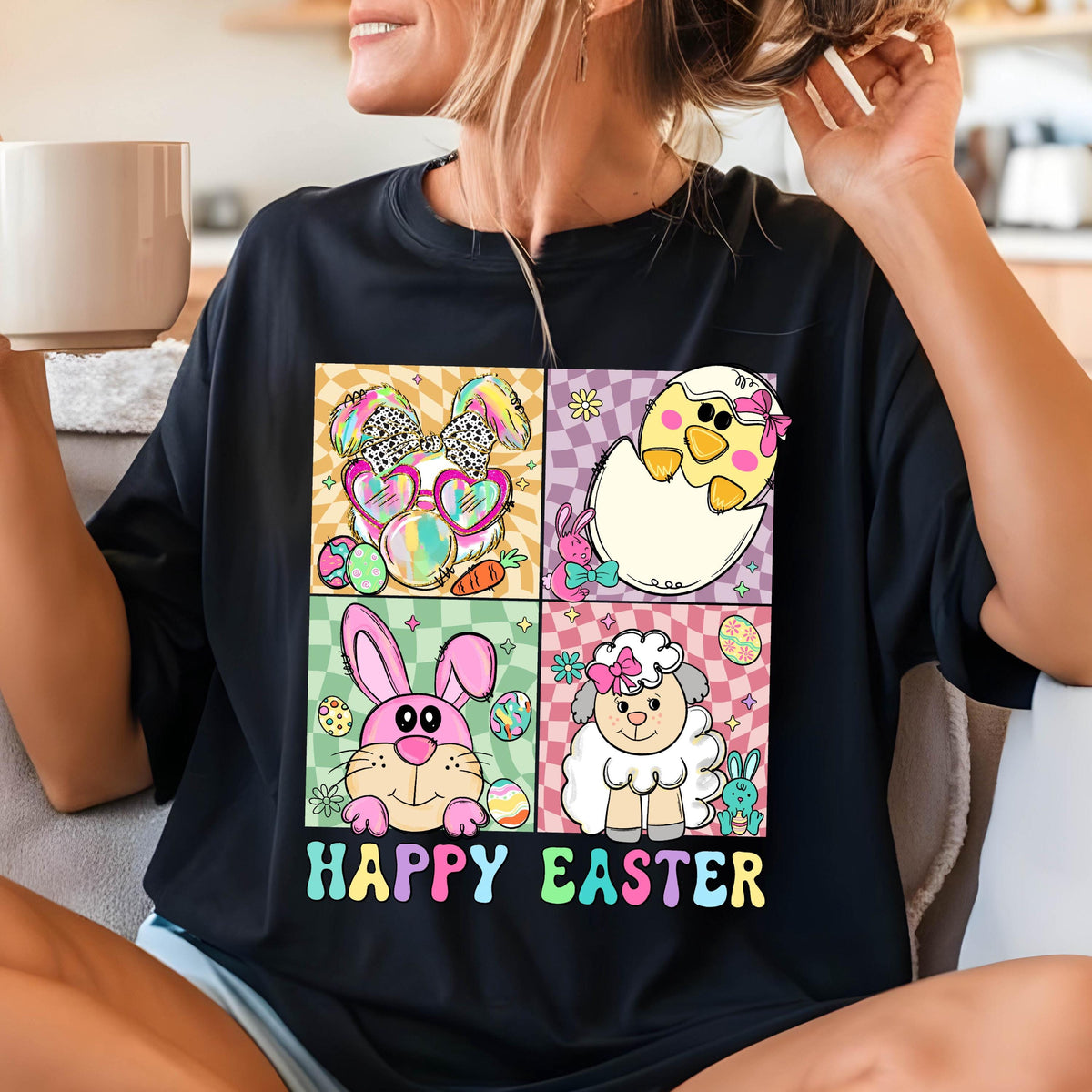 May include: Black t-shirt with a colorful graphic of four Easter animals: a bunny, a chick, a lamb, and a bunny wearing sunglasses. The text "Happy Easter" is printed below the graphic.