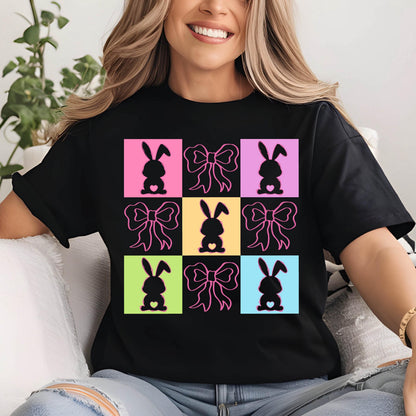 May include: Black t-shirt with a colorful design of bunnies with bows. The bunnies are in a grid pattern with each bunny in a different colored square. The bows are pink.