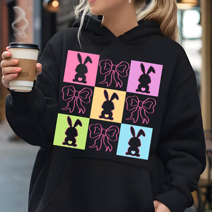 May include: Black hoodie with a colorful design of bunnies and bows. The design is in a grid pattern with each square having a different color.