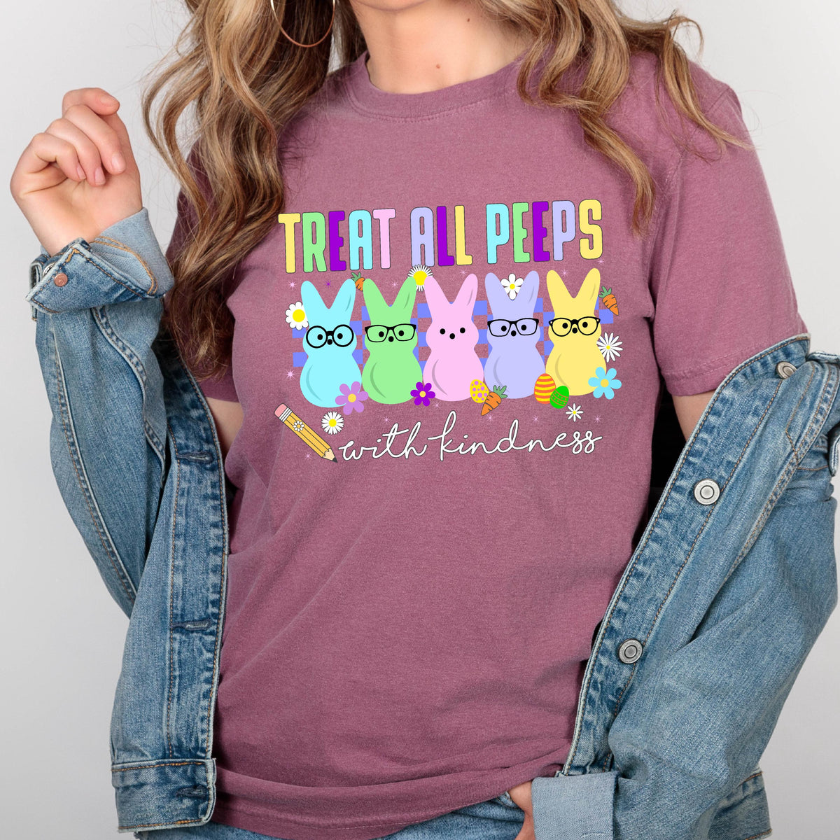 May include: A pink t-shirt with the text "Treat all peeps with kindness" and a graphic of five pastel-colored peeps wearing glasses. 