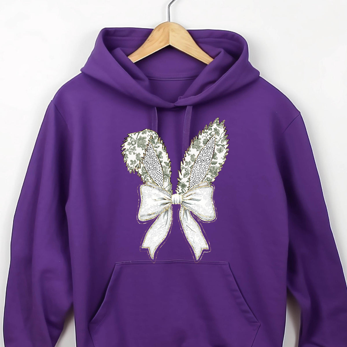 May include: Purple hoodie with a white bow and gold glitter bunny ears design.