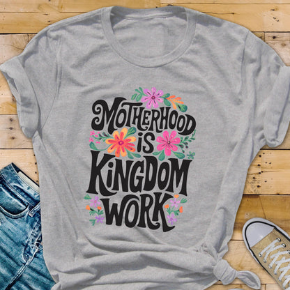 May include: Gray t-shirt with a floral design and the text "Motherhood is Kingdom Work" printed on the front.