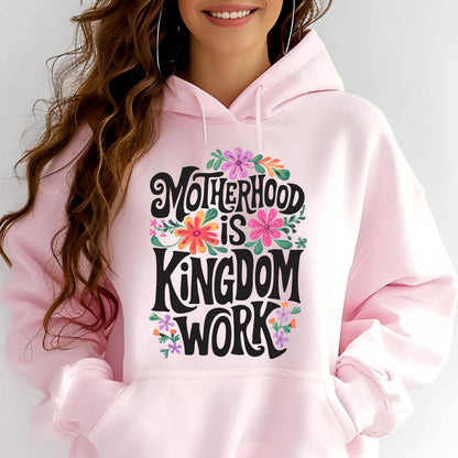 May include: Pink hoodie with a floral design and the text "Motherhood is Kingdom Work" in black lettering.
