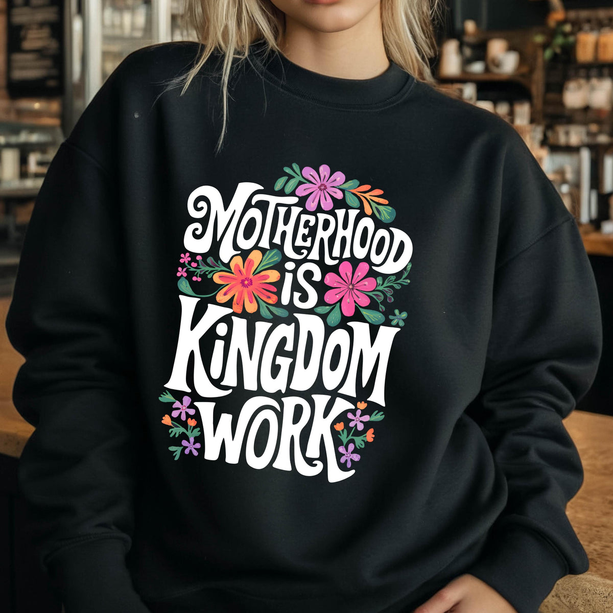 May include: Black sweatshirt with a white graphic that says "Motherhood is Kingdom Work" surrounded by colorful flowers.
