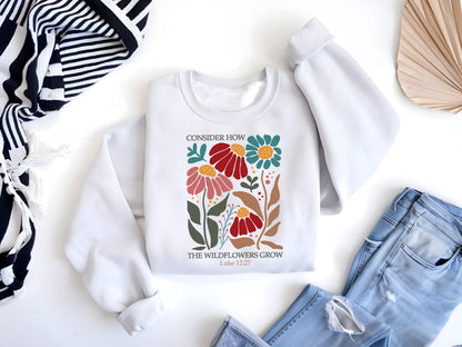 May include: White sweatshirt with a floral design and the text "Consider how the wildflowers grow Luke 12:27"