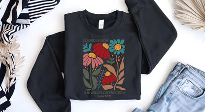 May include: Black sweatshirt with a floral design and the text "Consider how the wildflowers grow Luke 12:27".