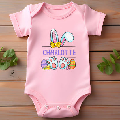 May include: Pink baby onesie with a cartoon bunny rabbit with Easter eggs and the name Charlotte.