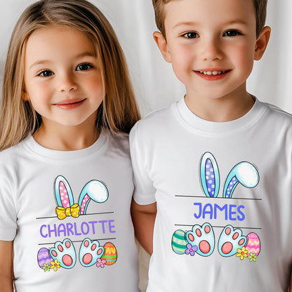 May include: Two white t-shirts with a bunny ear design and Easter eggs. The shirts have the names "Charlotte" and "James" printed on them.