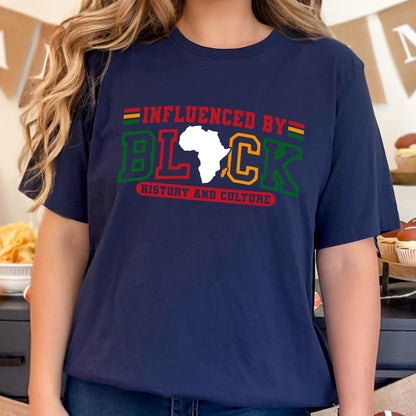 May include: A navy blue short-sleeve t-shirt featuring the text INFLUENCED BY in red, the word BLACK with a white silhouette of the African continent replacing the letter A, and the text HISTORY AND CULTURE in red below in green and yellow.