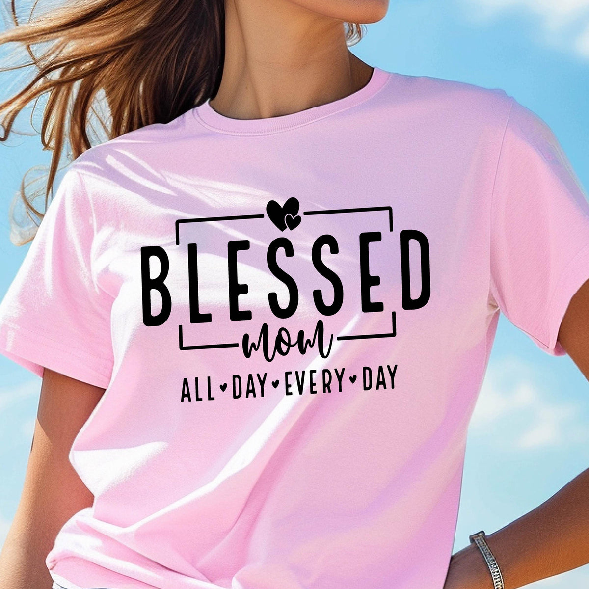 May include: Pink t-shirt with black text that reads "Blessed Mom All Day Every Day" with a heart symbol between each word.