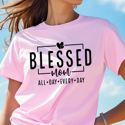 May include: Pink t-shirt with black text that reads "Blessed Mom All Day Every Day" with a heart symbol between each word.