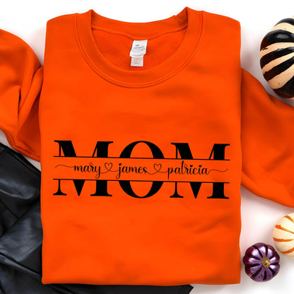 May include: Orange sweatshirt with black text that reads "MOM" with the names "mary", "james", and "patricia" underneath.