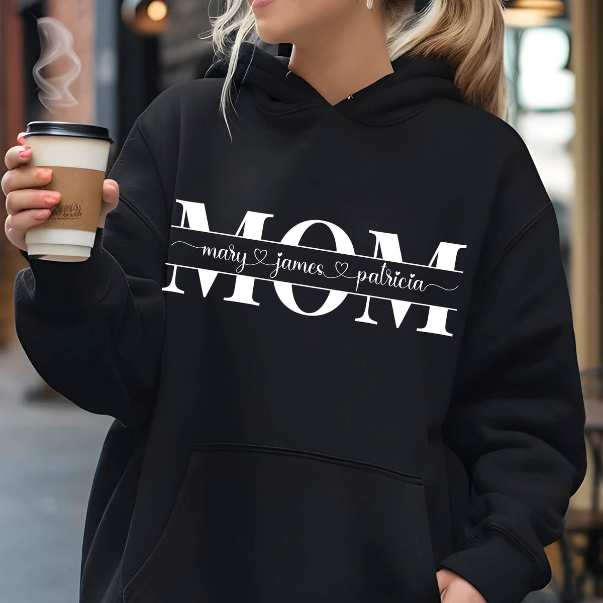 May include: Black hoodie with a white graphic that says "MOM" with the names "mary", "james", and "patricia" underneath.