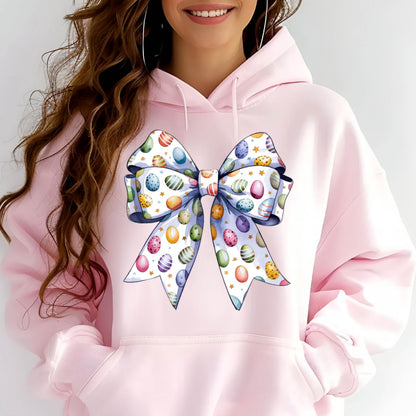 May include: Pink hoodie with a large white bow printed on the front. The bow is decorated with colorful Easter eggs.