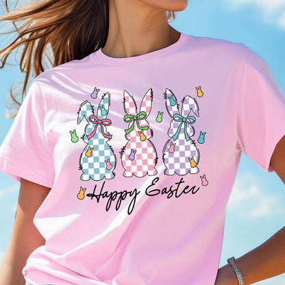 May include: Pink t-shirt with a graphic of three checkered Easter bunnies and the text "Happy Easter".
