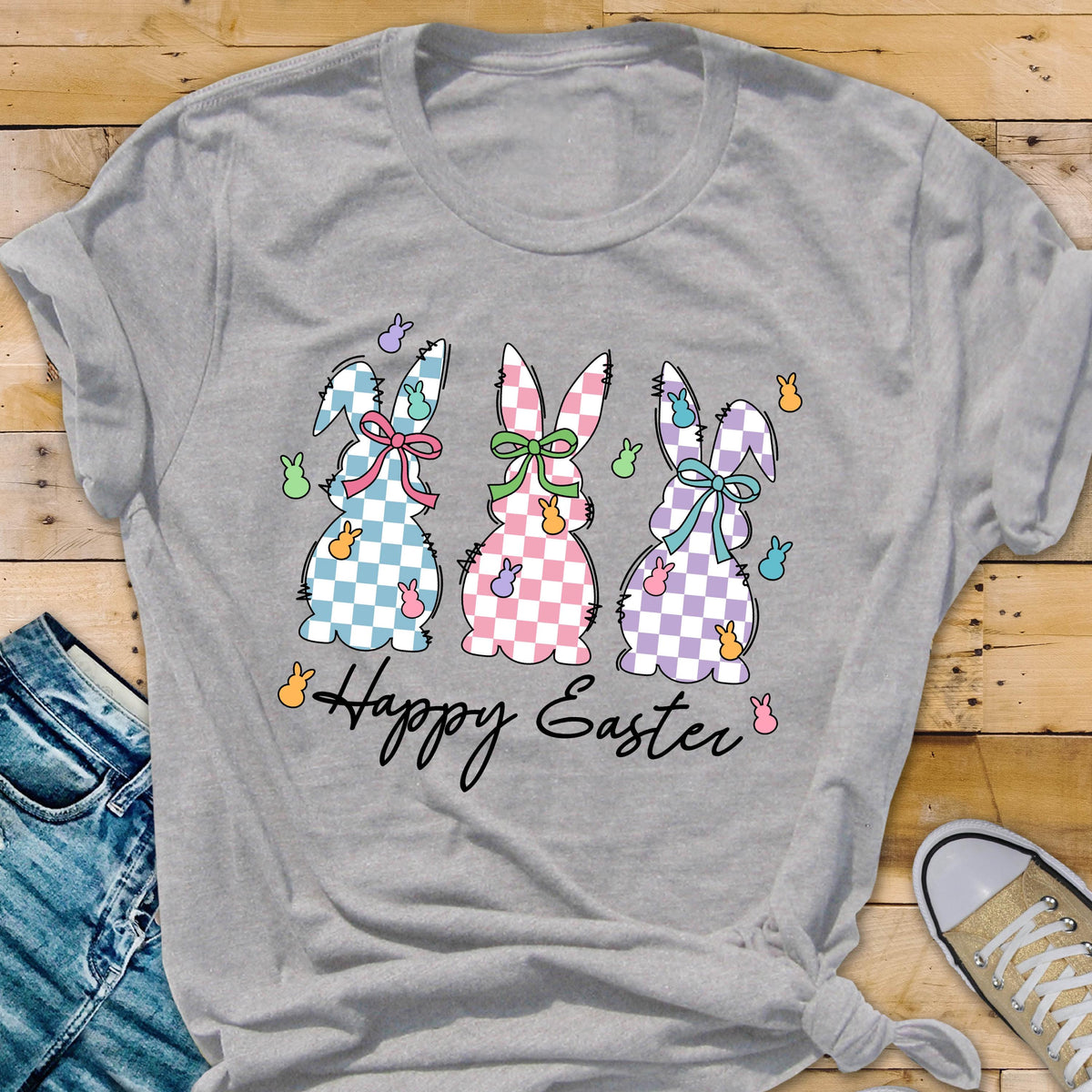 May include: A gray t-shirt with a graphic of three checkered Easter bunnies and the text "Happy Easter".