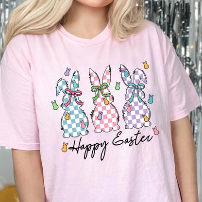 May include: Pink t-shirt with a graphic of three checkered Easter bunnies and the text "Happy Easter".