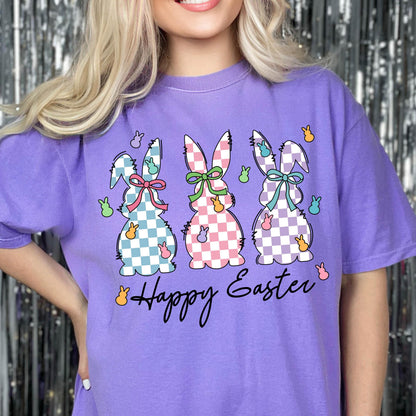 May include: Purple t-shirt with a graphic of three checkered Easter bunnies and the text "Happy Easter".