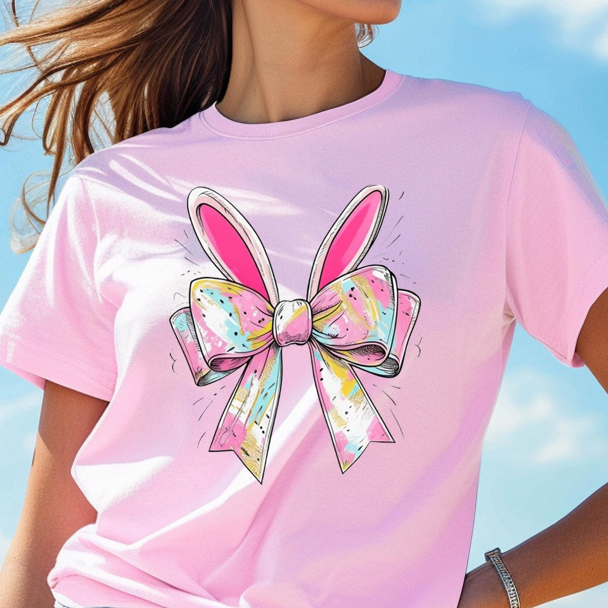 May include: Pink t-shirt with a colorful bow and bunny ears graphic.