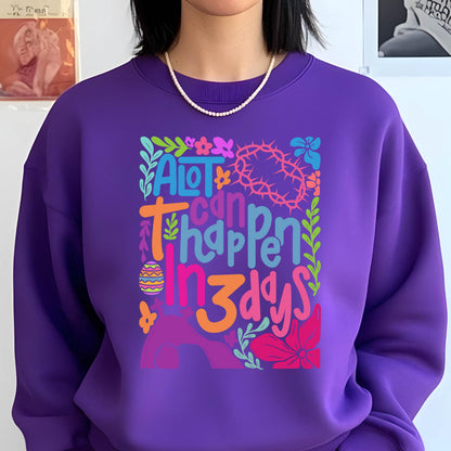 May include: Purple sweatshirt with a colorful graphic design that says "A lot can happen in 3 days". The graphic includes a crown of thorns, an Easter egg, and flowers.