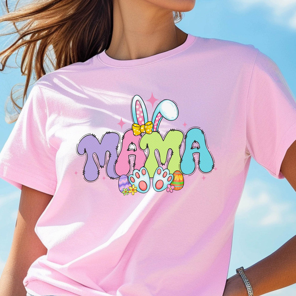 May include: Pink t-shirt with a colorful graphic of the word "MAMA" with bunny ears and Easter eggs.