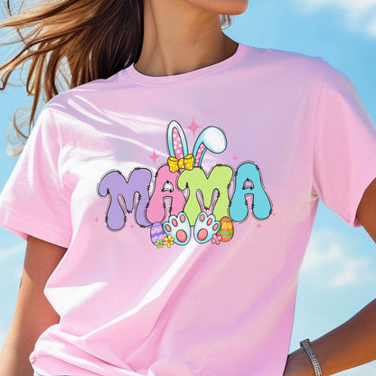 May include: Pink t-shirt with a colorful graphic of the word "MAMA" with bunny ears and Easter eggs.