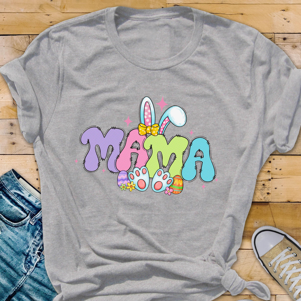 May include: A light gray t-shirt with a colorful graphic of the word "MAMA" with bunny ears and Easter eggs. 
