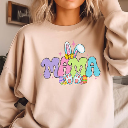 May include: A light beige sweatshirt with a colorful graphic of the word "MAMA" with bunny ears and Easter eggs. 