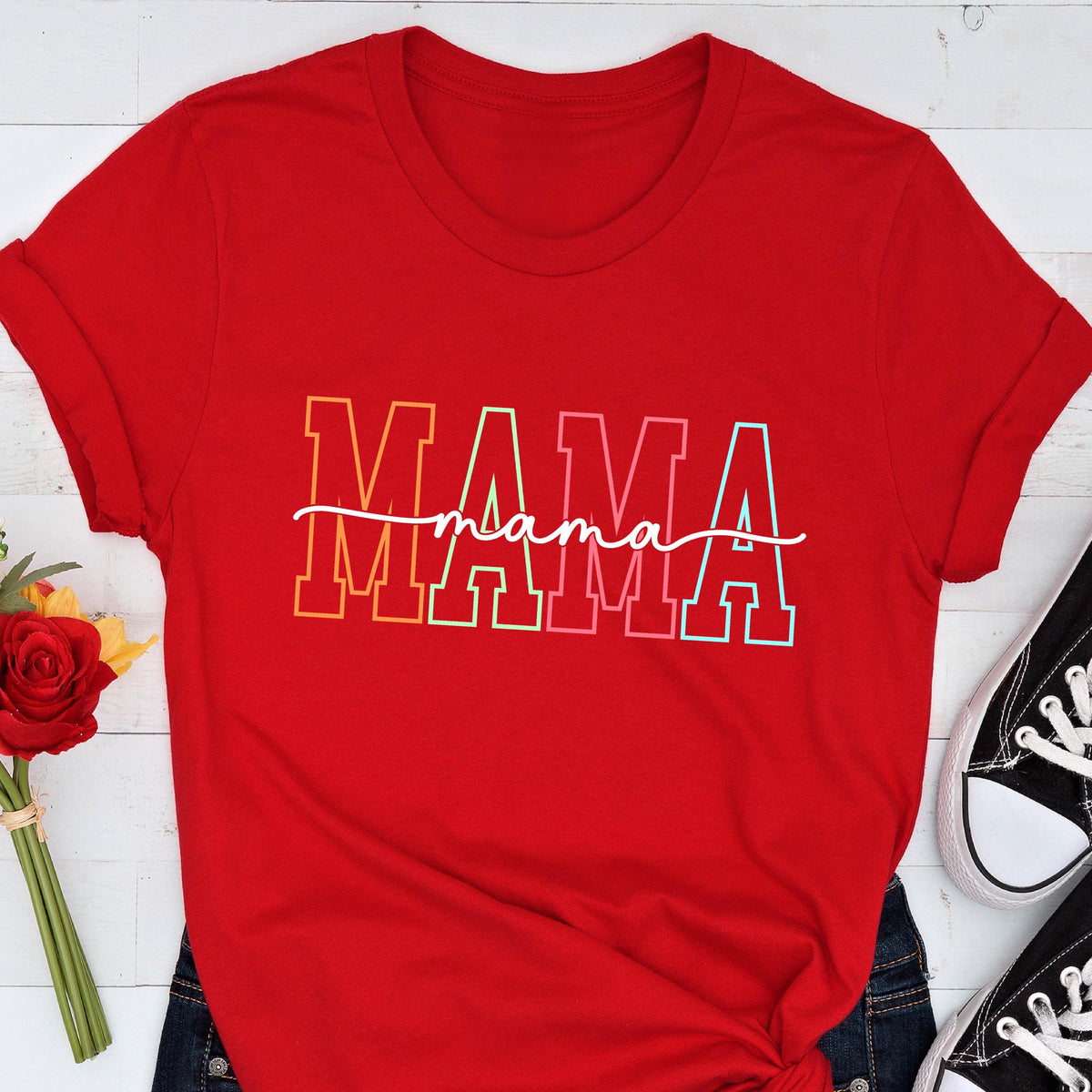 May include: Red t-shirt with a rainbow colored "MAMA" graphic with the word "mama" written in cursive underneath.