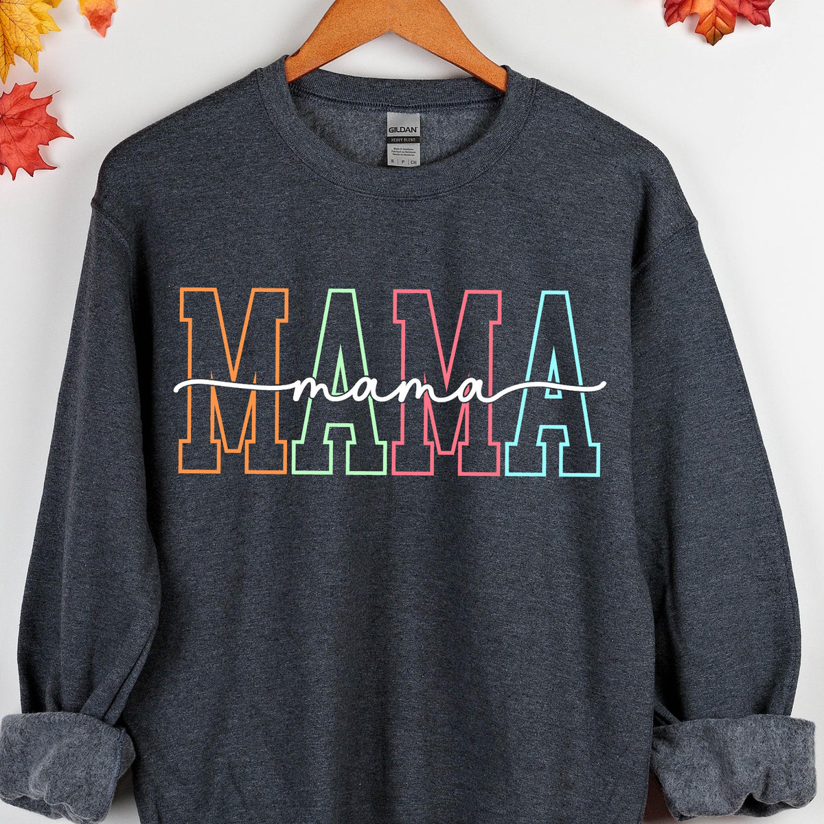 May include: A dark gray sweatshirt with the word "MAMA" in rainbow colors with a handwritten "mama" underneath.