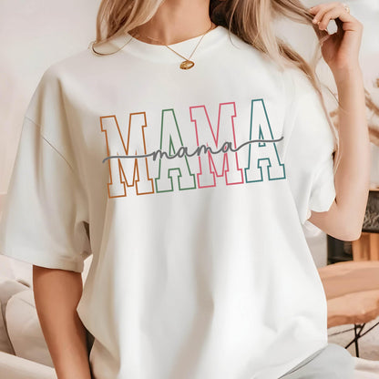 May include: White t-shirt with the word "MAMA" in colorful block letters with a handwritten "mama" underneath.