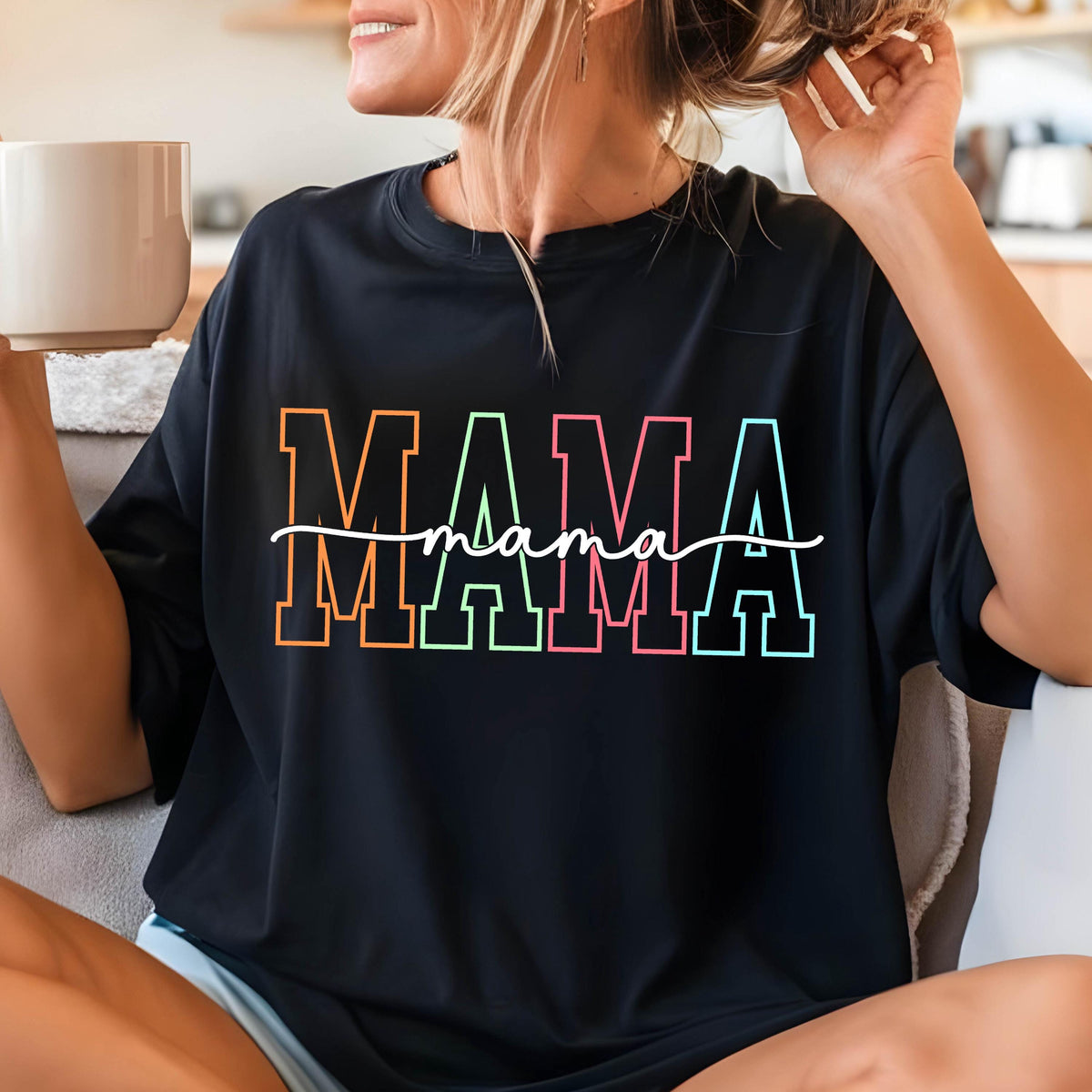 May include: Black t-shirt with a rainbow colored "MAMA" graphic with the word "mama" written in cursive underneath.