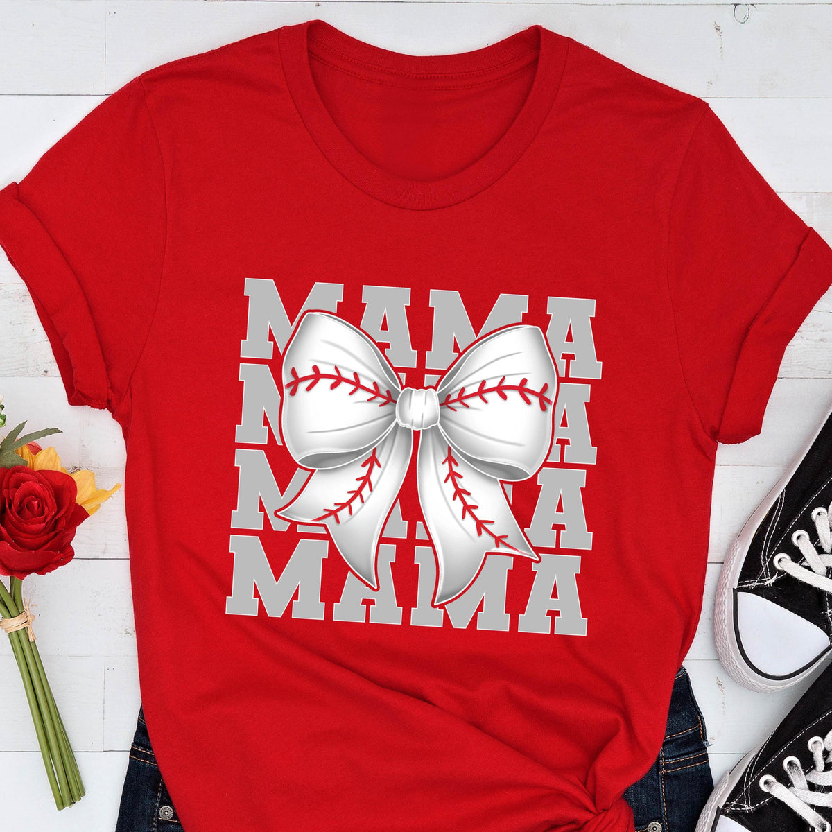 May include: Red t-shirt with a white baseball-themed bow and the text "MAMA" repeated four times in a stacked design.