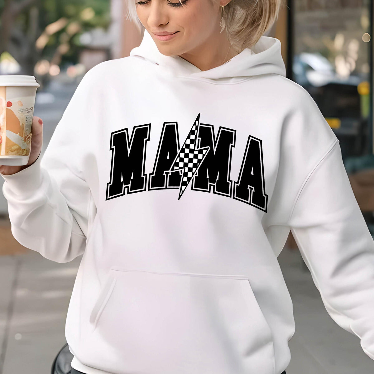 May include: White hoodie with a black graphic that says "MAMA" with a checkered lightning bolt in the middle.